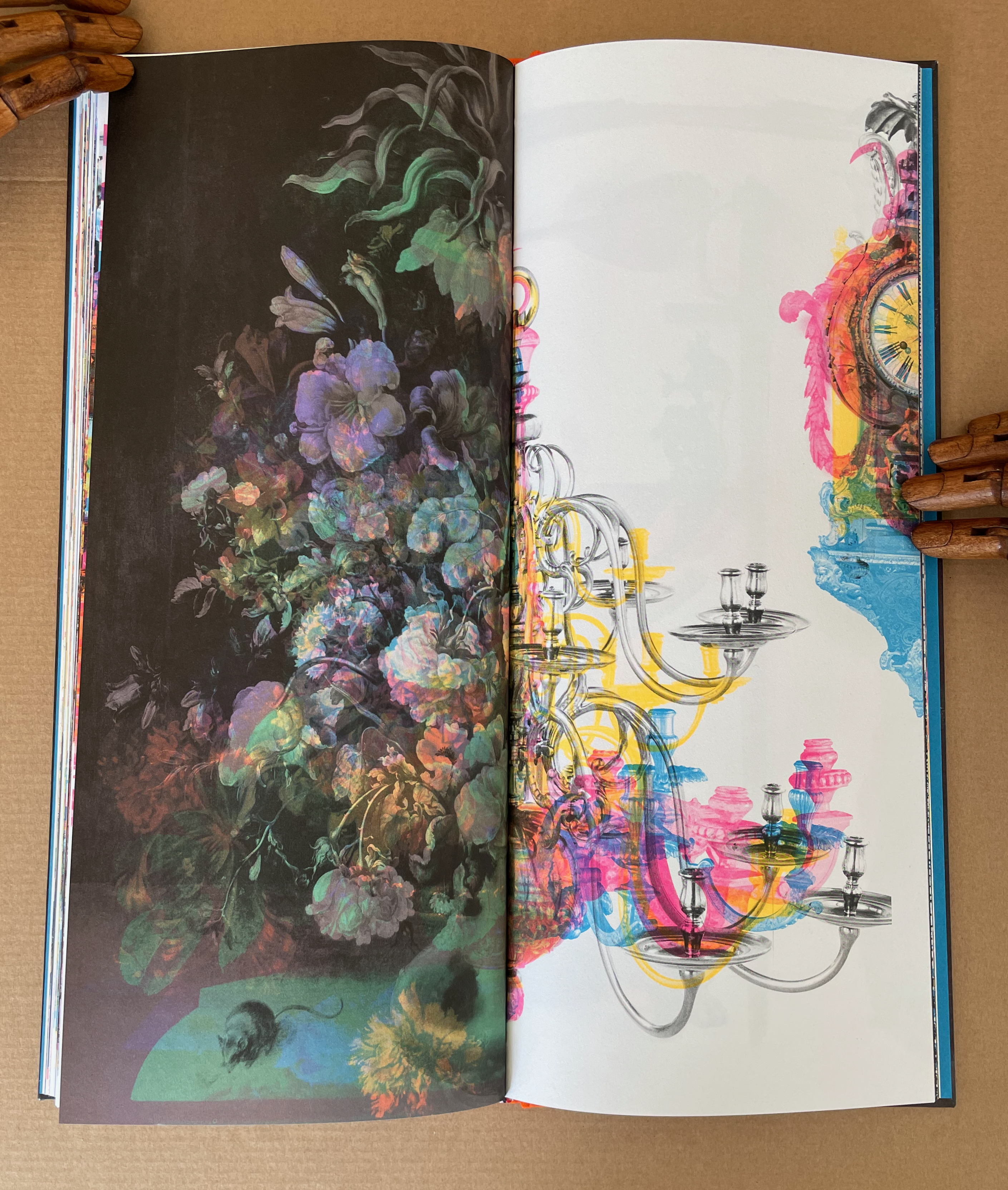 An open book showcasing a vibrant illustration featuring a floral composition on the left page and an ornate chandelier design on the right page, with a colorful background.