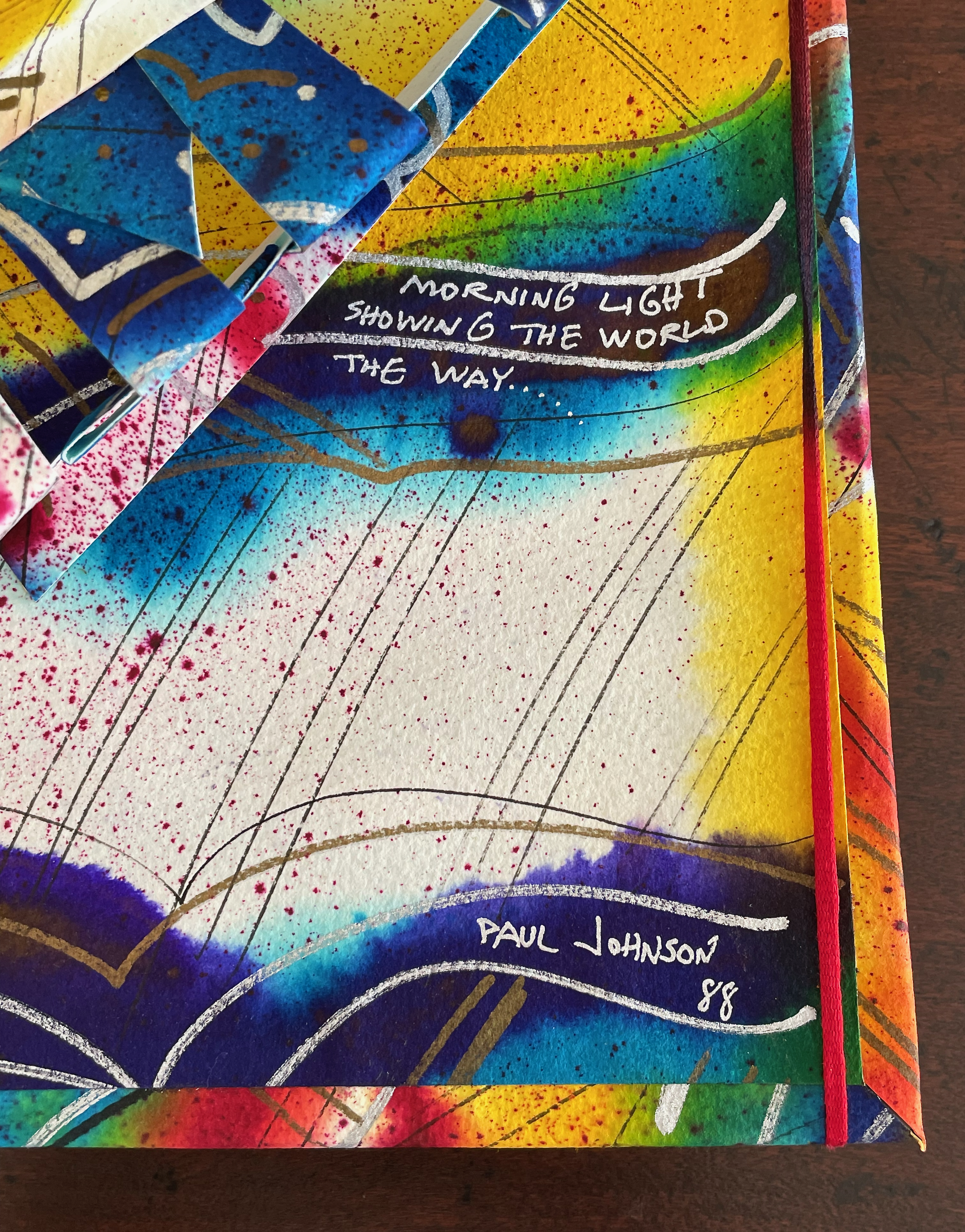 Abstract artwork featuring vibrant colors and dynamic shapes, with text that reads 'MORNING LIGHT SHOWING THE WORLD THE WAY...' and signed by Paul Johnson with the date '88'.