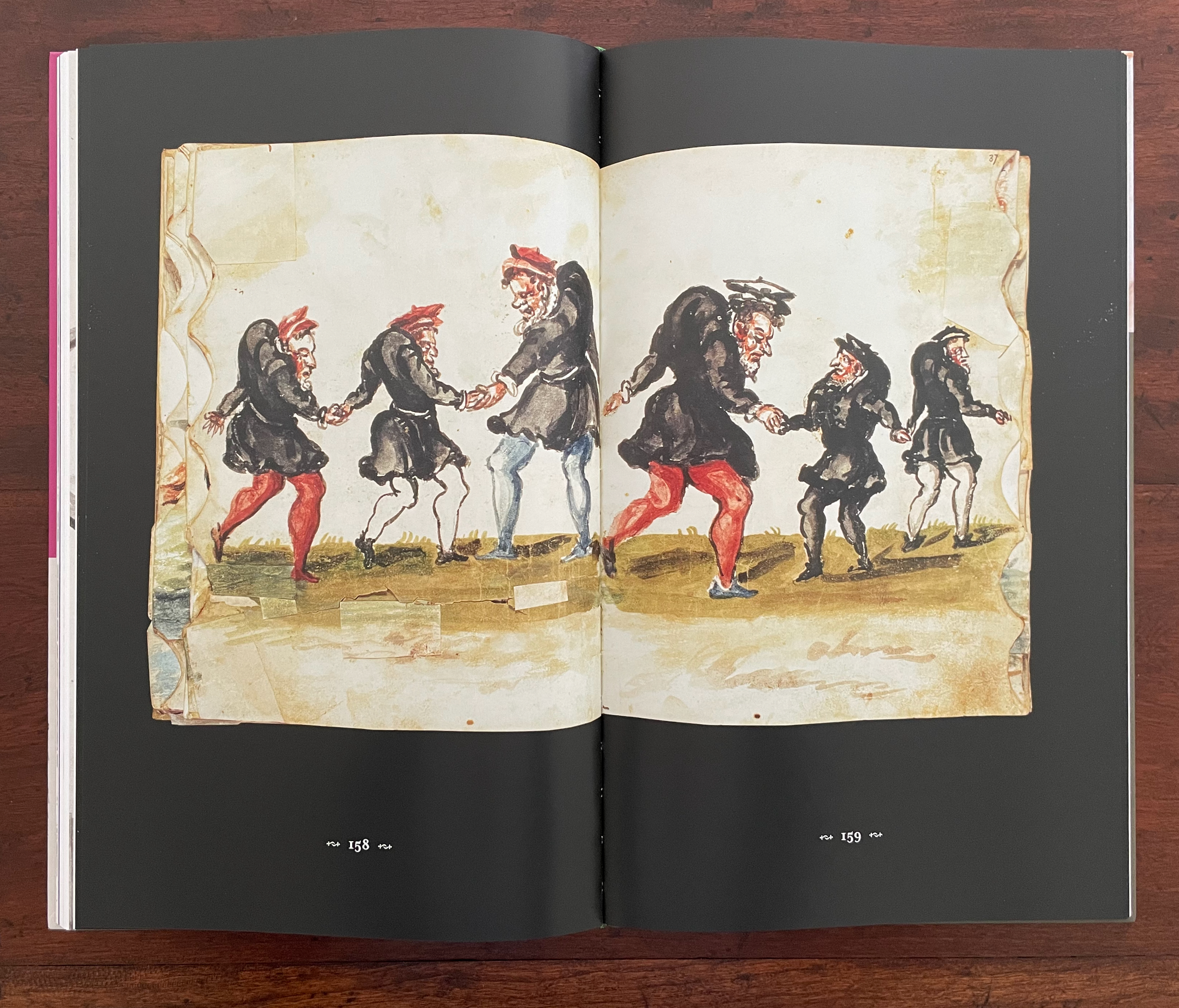 A colorful illustration from a book showing five figures in traditional attire, holding hands and dancing in a line on a grassy area.