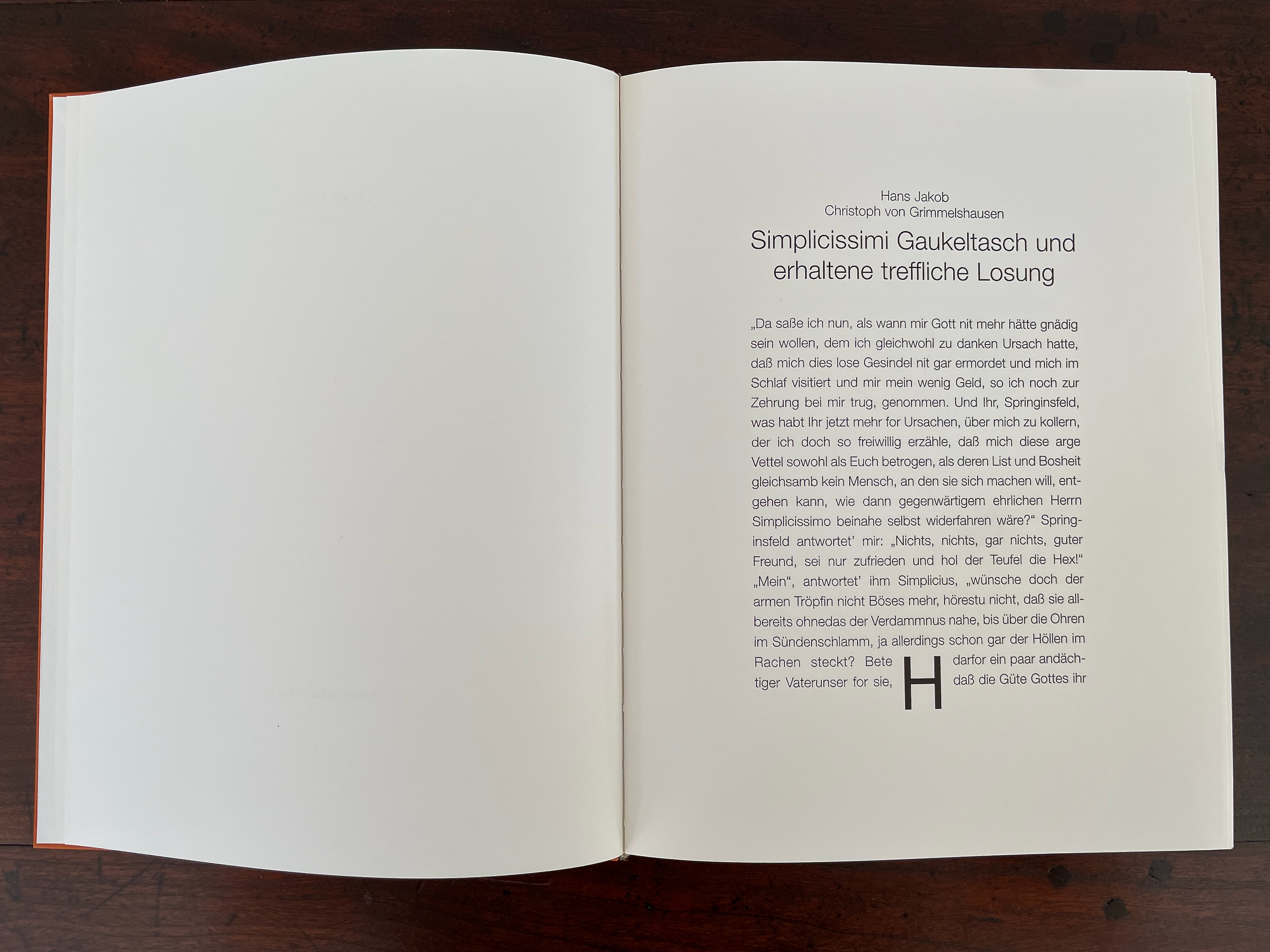 Open book pages with text in German titled 'Simplicissimi Gaukeltasch und erhaltene treffliche Lösung' by Hans Jakob and Christoph von Grimmelshausen. The left page is blank, while the right page contains a paragraph of text.