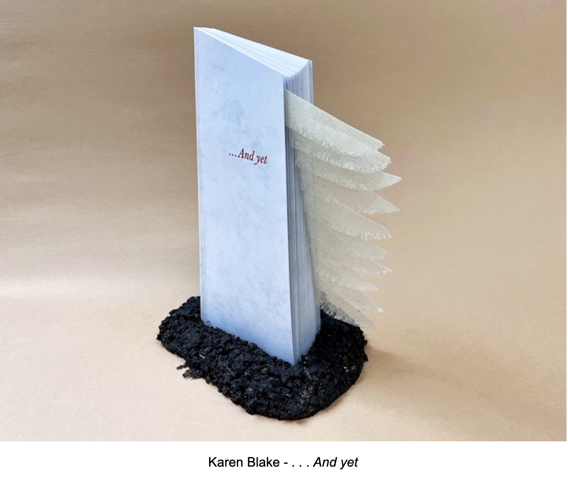 An artistic sculpture of a book titled '...And yet' by Karen Blake, featuring a textured spine and layered pages, placed on a dark, textured base.