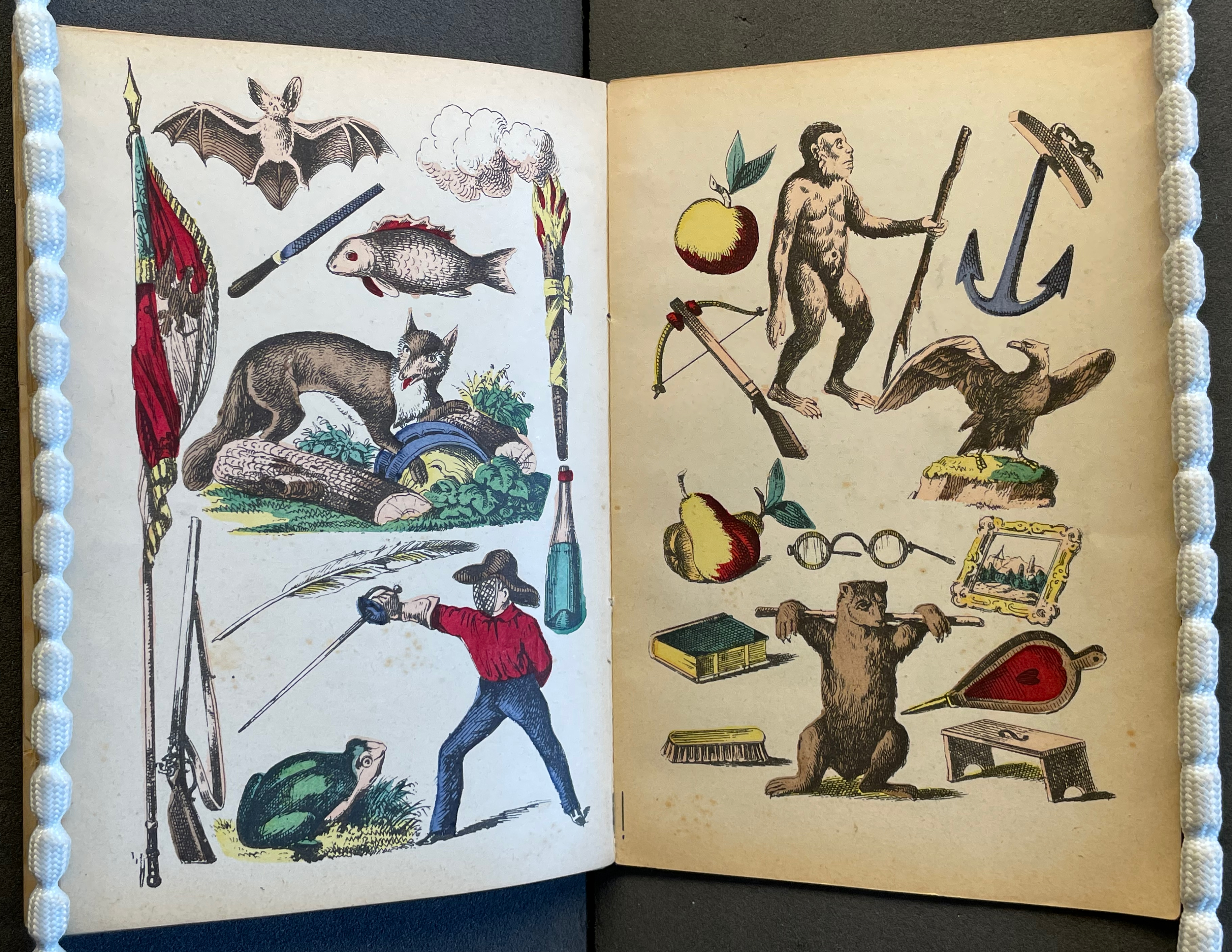 Illustration of various animals, objects, and figures including a bat, fish, fox, apple, eagle, and a human figure holding a spear, alongside items like flags, weapons, and books.